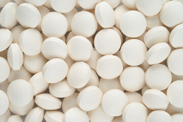 Fototapeta na wymiar White round pills texture. Top view
