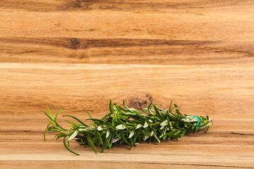 Rosemary on a wooden background.