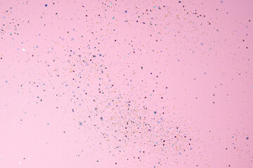 Sequins on pastel pink background. Festive concept. High quality photo. A great background for a holiday card, wedding or birthday invitation or advertisement. Copy Space