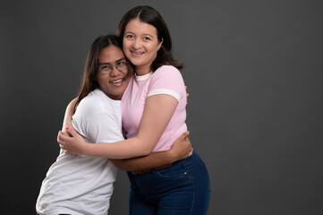 Fototapeta premium Two young hispanic people hug
