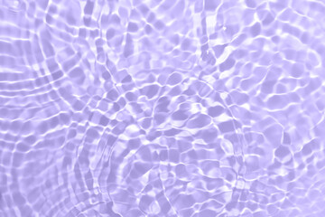 Rippled water background with circles and splashes. Purple, violet, blue abstract texture
