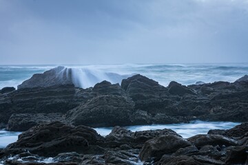 Long exposure of blue sea waves roaming on the cliffs