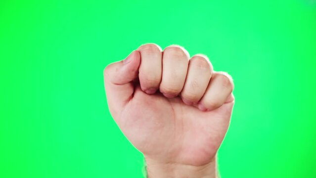 Fist knocking the screen, woman showing hand gesture attention on green chroma key background in studio. 