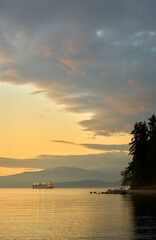 Fototapeta na wymiar Seawall at Sunset English Bay. The Stanley Park Seawall on English Bay at sundown. Vancouver, British Columbia.