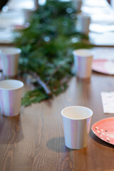 Striped shining recycled paper glasses on a party tableware