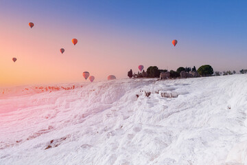 Travel landscape of Turkey. Pamukkale Hot air balloon flying Travertine pool and terraces sunset
