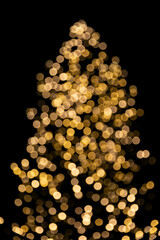 Bokeh golden lights of Christmas tree isolated on black background