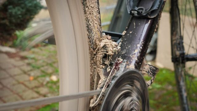 Mechanic shifts gears on dirty gravel bicycle. Close up of bicycle gear