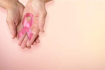 Human hand hold pink ribbon. Breast cancer concept