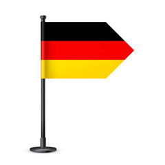 Realistic German table flag on a black steel pole. Souvenir from Germany. Desk flag made of paper or fabric and shiny metal stand. Mockup for promotion and advertising. Vector illustration