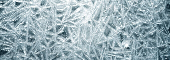 The texture of the ice surface. Winter background, festive background in the form of ice crystals.