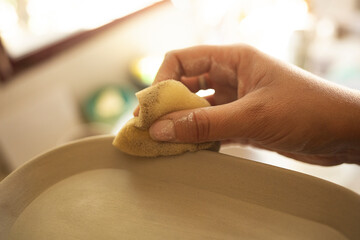 Artist smoothing surface of a craft made at home