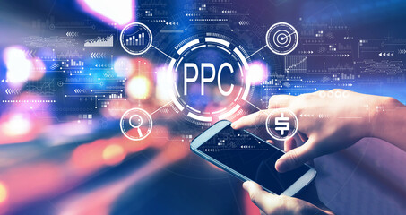 PPC - Pay per click concept with person using a smartphone in a city at night