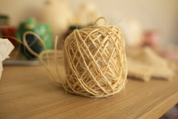 roll of natural thread on a wooden table
