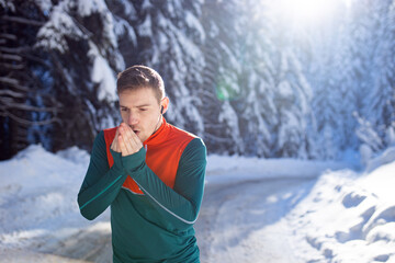 Male runner warming up at winter time