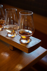 Flight of single malt scotch whisky in glasses served in whiskey bar in Edinburgh, UK