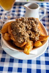 Scottish traditional snack food, hand cut potato chips topped with haggis and gravy