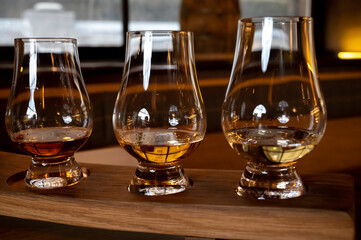 Flight of single malt scotch whisky in glasses served in whiskey bar in Edinburgh, UK