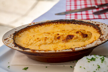 Quenelle, speciality of Lyon, oval-shaped dumplings filled with pike white fish served in creamy sauce in traditional Lyonnaise Bouchon, France