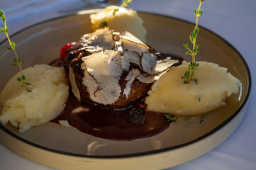Beefsteak served with fresh black truffle mushroom and balls of mashed potato in French restaurant