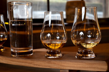 Flight of single malt scotch whisky in glasses served in whiskey bar in Edinburgh, UK
