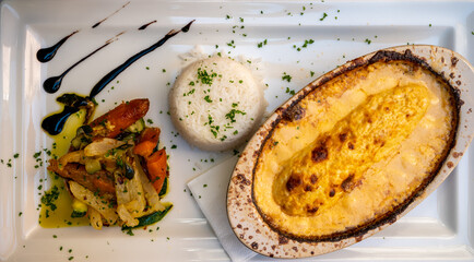 Quenelle, speciality of Lyon, oval-shaped dumplings filled with pike white fish served in creamy...