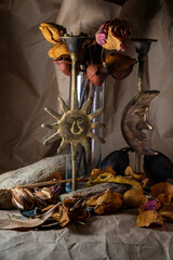 Fall still life including sun and moon candle sticks