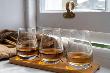 Flight of single malt scotch whisky served on old wooden window sill in Scottisch house in Edinburgh, Scotland, UK