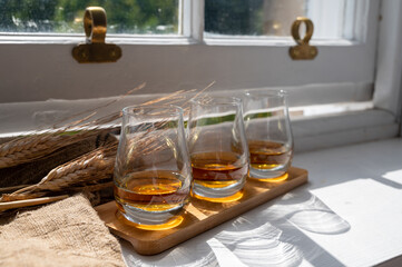 Flight of single malt scotch whisky served on old wooden window sill in Scottisch house in Edinburgh, Scotland, UK