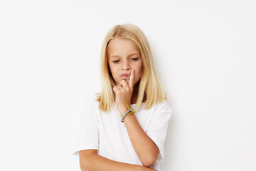 Little cute girl with blond hair posing studio