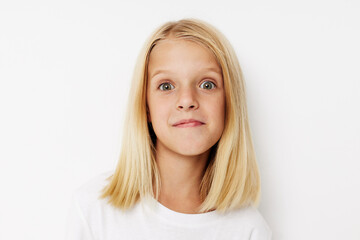 happy child with blond hair on a light background