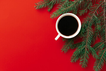Obraz na płótnie Canvas cup of coffee on red holidays background. Christmas mood background