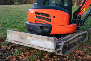 Fragment of orange excavator and crawler bulldozer.