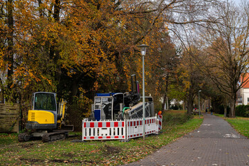 Obraz premium Excavator and trench digging machine at a small construction site.