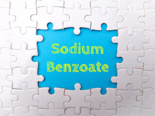 White puzzle with the word Sodium Benzoate on a blue background.