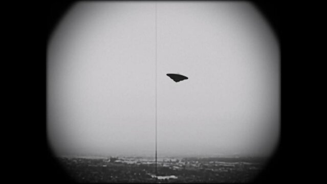 KINESCOPE LOOKING FOOTAGE OF A FLYING SAUCER HOVERING OVER A VALLEY.  FULL HD IN BLACK AND WHITE.