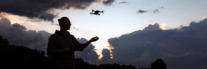 Banner man controlling a drone with a remote control