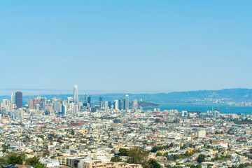 Skyscrapers in sprawling downtown city scape with neighborhoods and buildings and houses in San Francisco California midday or late afternoon