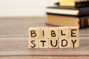Bible study text on wood cubes on rustic table with Holy Bible, notebook, and pen in the...