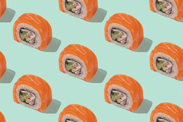 Japanese sushi with salmon, dragon rolls on a pastel green background. Pop art, background, pattern. © Alona Dudaieva