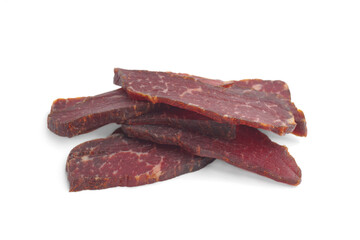 Pieces of delicious beef jerky on white background