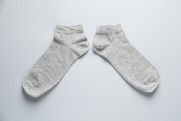 Pair of socks on light grey background, flat lay