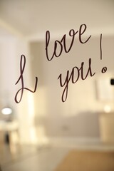 Handwritten text I Love You on mirror in room. Romantic message