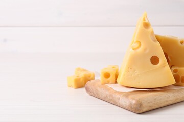 Tasty fresh cheese on white wooden table, closeup. Space for text