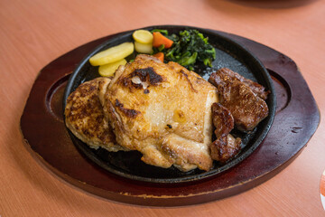 This image shows a beautifully plated meat and vegetable dish on a restaurant table.