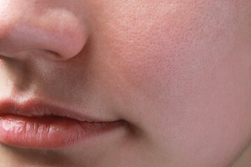 Closeup view of woman with normal skin and beautiful lips