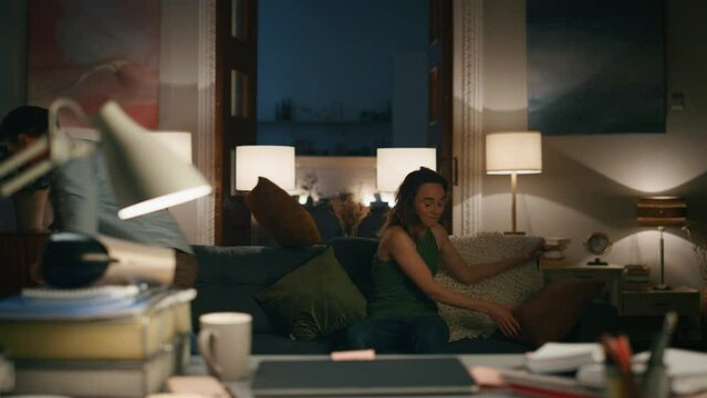 Playing couple fighting flat closeup. Funny woman throwing pillow at spouse