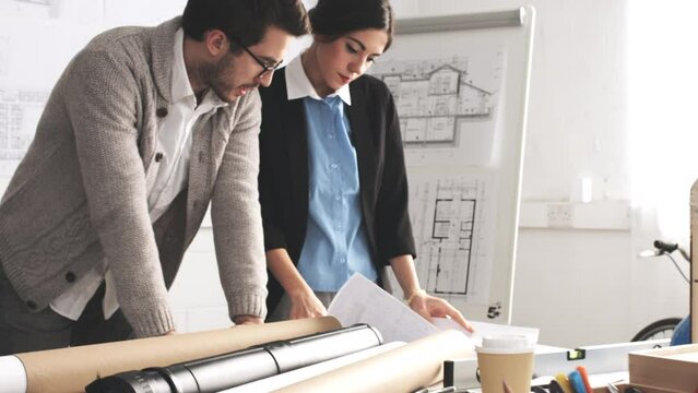 Architect, blueprint and collaboration with a man and woman team working together on design in their office. Building, architecture and teamwork with a male and female designer planning at work