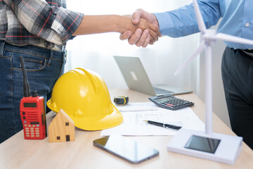 Construction engineers join hands and are happy to work with customers Successful team building  man or builder group handshake together at the office after the home project is done, a good deal