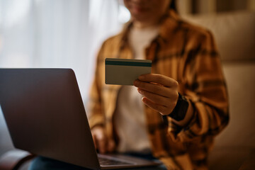 Close up of woman shopping online at home.